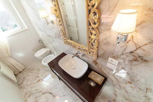 a bathroom with a sink and a mirror at Villa Francesca Relais in Gradara