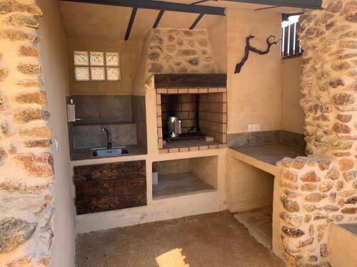 a small kitchen with a stove and a sink at Marquina Rural in Cubillo del Butrón