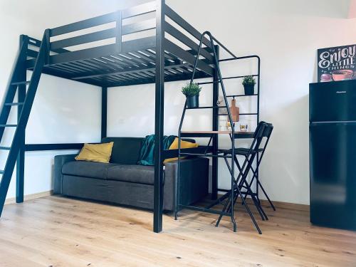 a loft bed with a couch and a desk in a room at Trevi industrial room C in Milan