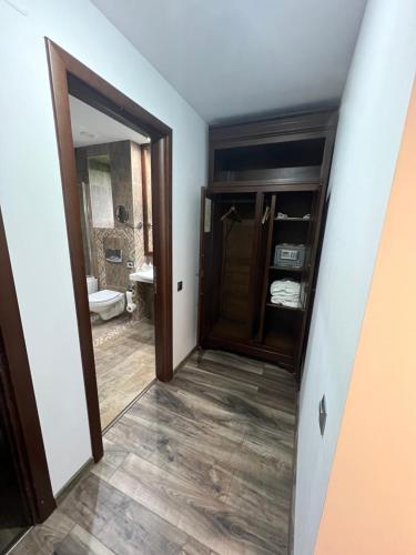 a hallway with a door leading to a bathroom at Alpin Resort Apartments Deluxe 2406 in Poiana Brasov