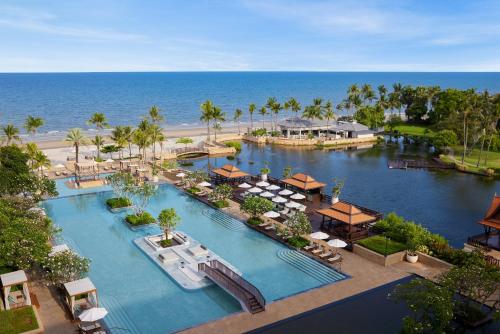 an aerial view of a resort with a pool and a beach at Dusit Thani Hua Hin in Cha Am