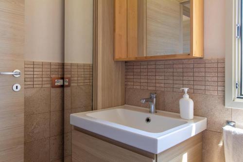 a bathroom with a sink and a mirror at Casa vacanza Il Melograno in Santa Maria Del Focallo