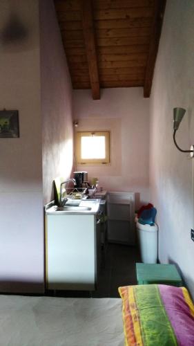 a small kitchen with a stove and a sink at La Volpe e la Luna in Mioglia