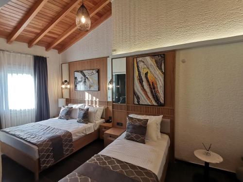 a hotel room with two beds and a window at The ABC Hotel in Alaçatı