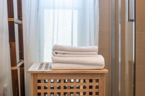 a stack of towels on a table in a bathroom at Boutique Hideaway Studio in Nida in Nida