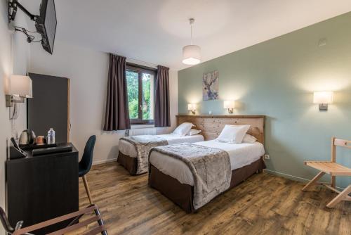 Letto o letti in una camera di Hôtel Le Marintan