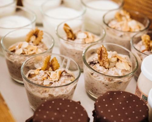 a group of glass cups filled with overnight oats at Der Schlosswirt zu Anif - Biedermeierhotel und Restaurant in Anif