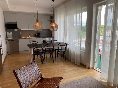 a kitchen and dining room with a table and chairs at Luxury Business Apartments 2 rooms #2 1-4 people in Sundbyberg