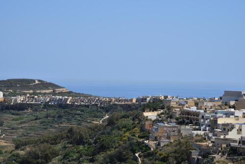 a city on a hill with houses at San Pawl B&b farmhouse- KORTOLL in Tal-Barmil