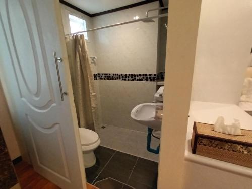 a bathroom with a toilet and a sink at Cana Boutique Hotel in Bangkok