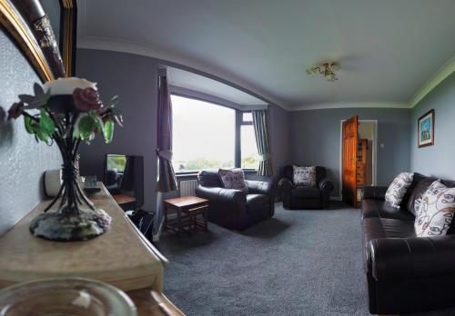 a living room with a couch and chairs and a window at Horizon View Portstewart Tourist Board approved in Portstewart