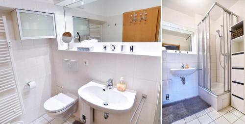 ein weißes Bad mit einem Waschbecken und einem WC in der Unterkunft GODS06006-FeWo 'Luv un Lee' in Gollendorf