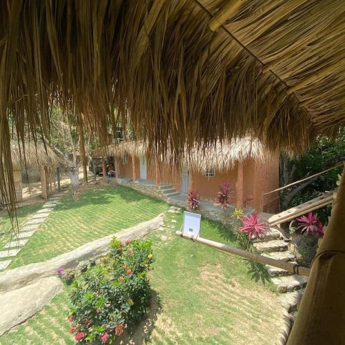 an outside view of a house with a garden at Hostal Dos Quebradas in Santa Marta