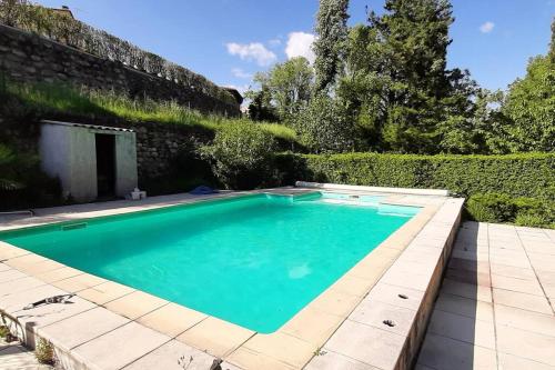 a swimming pool in the yard of a house at Gîte de charme dans Mas Catalan in Prades