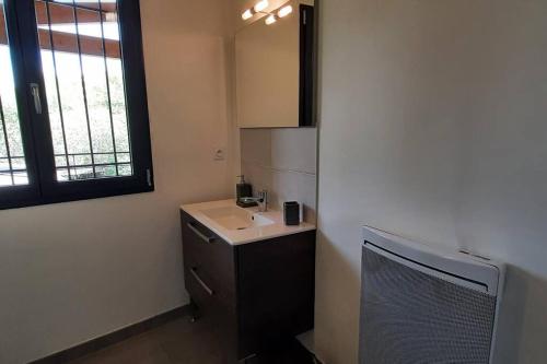 a bathroom with a sink and a mirror at Gîte de charme dans Mas Catalan in Prades