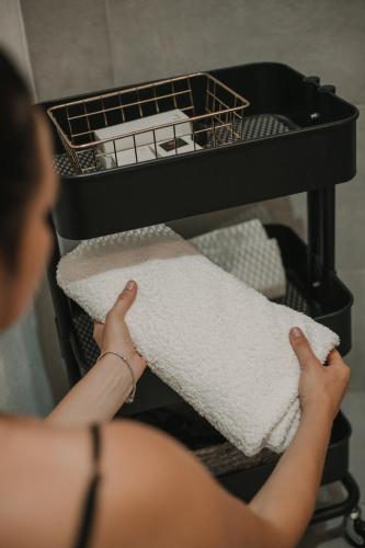 a woman is holding a towel on a shelf at Gallery Apartment 1 in Martin