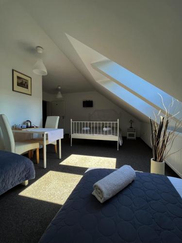 a bedroom with a bed and a crib in a attic at Gospoda Magurska in Sękowa