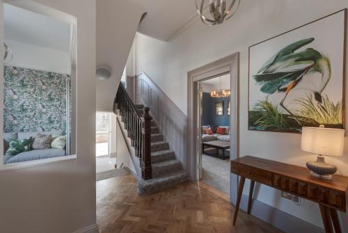 a hallway with a stairway with a painting on the wall at Stattons Boutique Hotel & Restaurant in Portsmouth
