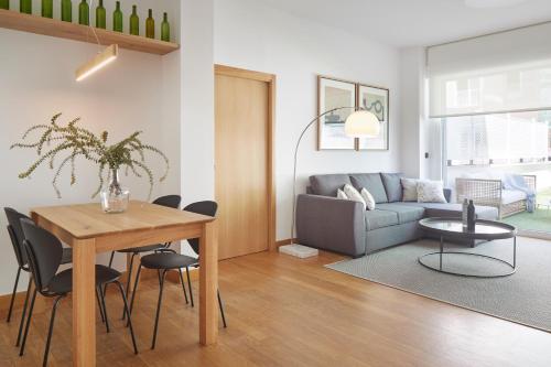 a living room with a table and a couch at Arzak by FeelFree Rentals in San Sebastián