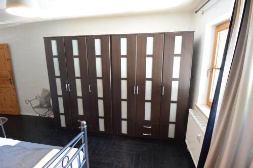 a bedroom with a large wooden sliding door at Alpenchalet Karwendel in Mittenwald