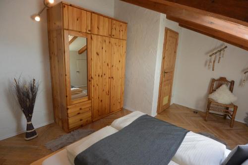 a bedroom with a bed and a wooden cabinet at Alpenchalet Karwendel in Mittenwald