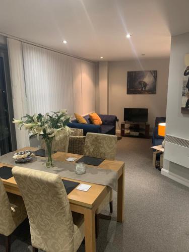 a living room with a table and a couch at City Centre Penthouse Apartment in Sunderland