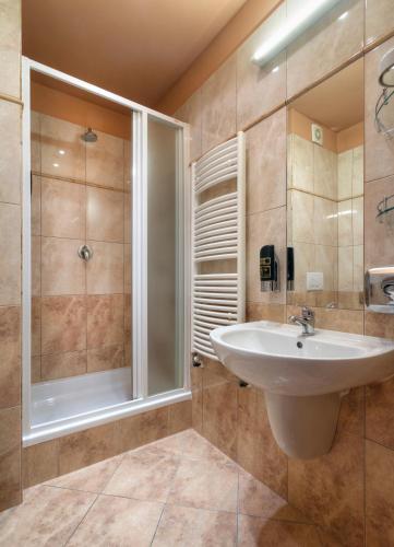 a bathroom with a sink and a shower at Atlantic Hotel in Prague