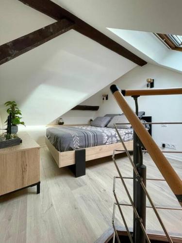 a bedroom with a bed in a attic at Petit studio vue lac / La Talloirdaze in Talloires