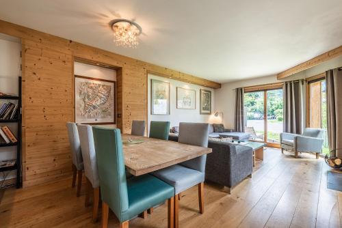 a dining room with a table and chairs at Eden Hotel, Apartments and Chalet Chamonix Les Praz in Chamonix-Mont-Blanc