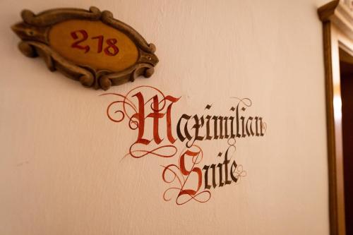 a sign on a wall with a clock on it at Alpenhotel Kramerwirt in Mayrhofen