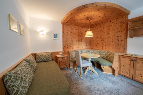 a living room with a couch and a table at Alpenhotel Kramerwirt in Mayrhofen
