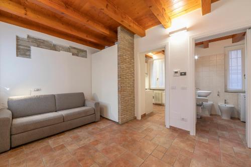 a living room with a couch and a bathroom at VIA 5 GIORNATE 13 - Apartment in Como