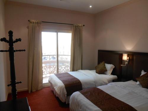 Tempat tidur dalam kamar di Samaya Al Khobar Hotel Apartments
