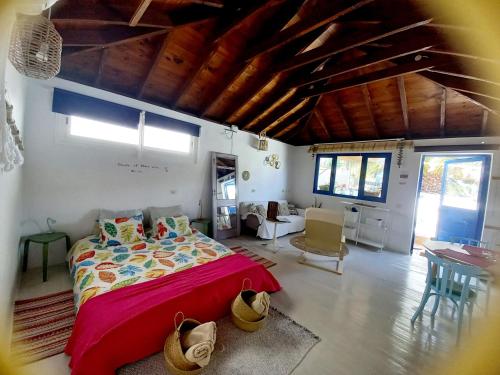 a bedroom with a bed and a living room at Eco Casa Alma,Montaña, Campo y Playa in Tabayesco