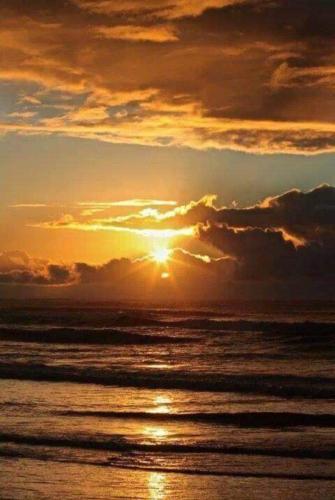 a sunset over the ocean with the sun setting at KALLIOPI'S HOUSE in Zilotí