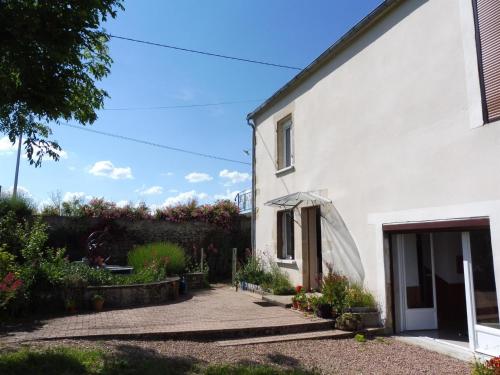 a white house with a garden and a patio at Gîte d'Haute-Cour in Moraches