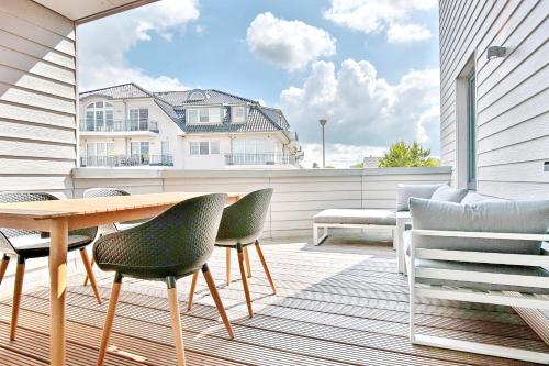 a patio with a table and chairs on a balcony at Ostsee Suite 5 - Strandperle in Niendorf