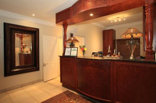 a reception desk in a room with a mirror at Cinnamon Boutique Guest House in Wilderness