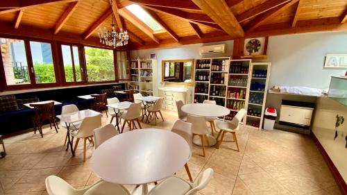 a dining room with tables and chairs in a library at Residence Al Lago in Castiglione del Lago