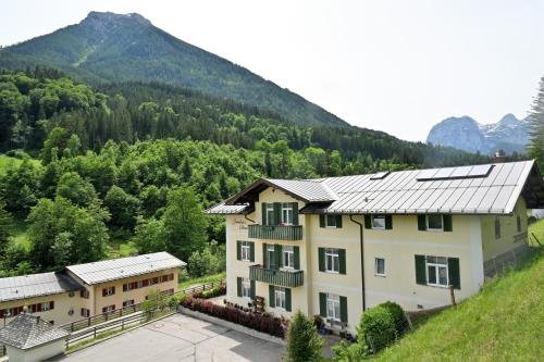 an image of a house with mountains in the background at Gasthof Oberwirt in Ramsau