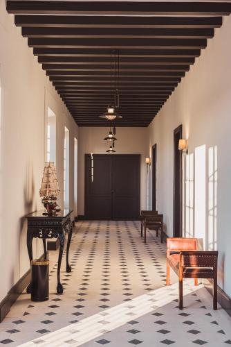 a hallway with a black door and a table and chairs at Château Laffitte Carcasset in Saint-Estèphe