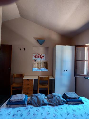 a bedroom with a bed and a table and a refrigerator at Quinta Cunte - Casa Girassol in São Luis