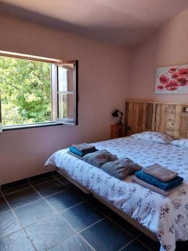 a bedroom with a bed and a window at Quinta Cunte - Casa Girassol in São Luis