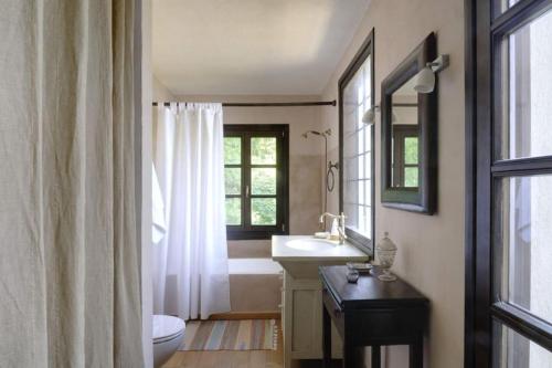 a bathroom with a sink and a toilet and a window at Bird's eye-view in Zagora
