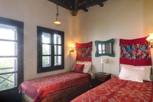 a bedroom with two beds and a window at Bird's eye-view in Zagora