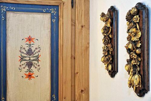 two pieces of art on a wall with a picture at Luxury Apt Dolomites 2 in Pinzolo