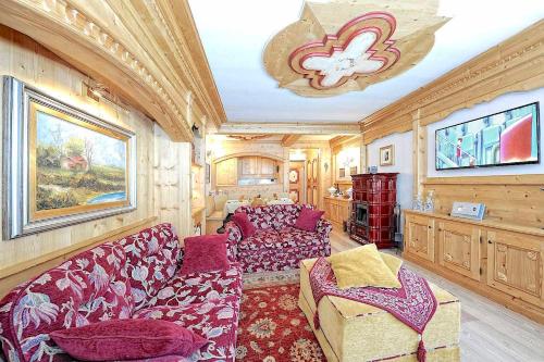 a living room with a couch and a chair at Luxury Apt Dolomites 2 in Pinzolo
