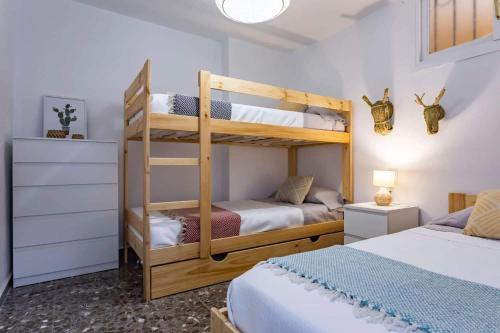a bedroom with two bunk beds and a bed at Apartamento El Palmer in Almería