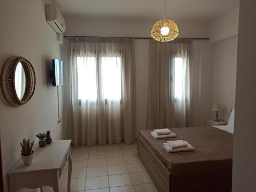 a bedroom with a bed with two towels on it at Sea melody apartments in Stavromenos