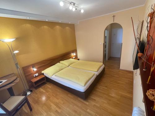 a bedroom with a bed and a table and a chair at Gasthof Wösner in Münzkirchen